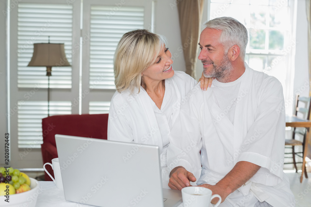 Mature couple using laptop