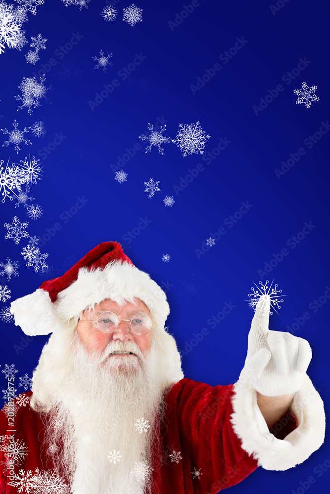 Santa claus pointing against blue Santa claus pointing against blue