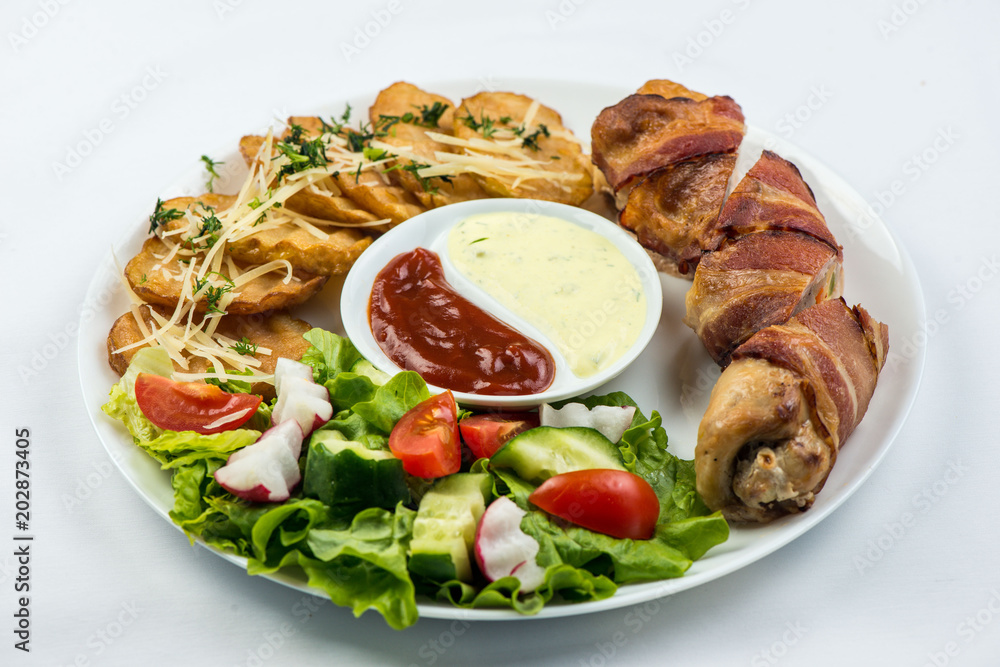 Delicious Chicken rolls with cheese and bacon on a plate close-up. horizontal