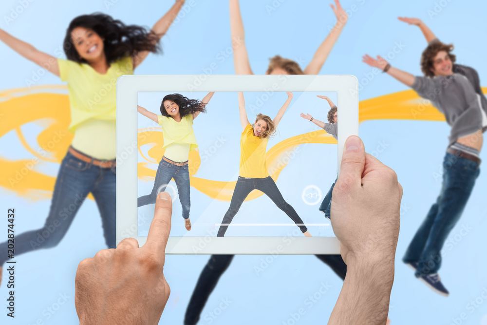 Composite image of hand holding tablet pc showing photograph Composite image of hand holding tablet pc showing photograph