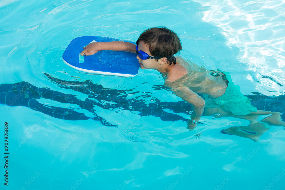 Boy swimming in the pool 