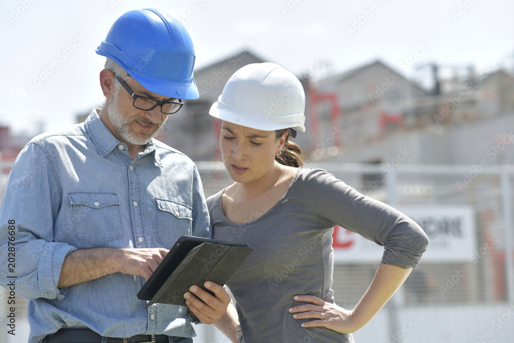 Construction engineers using tablet on building site Construction engineers using tablet on building site
