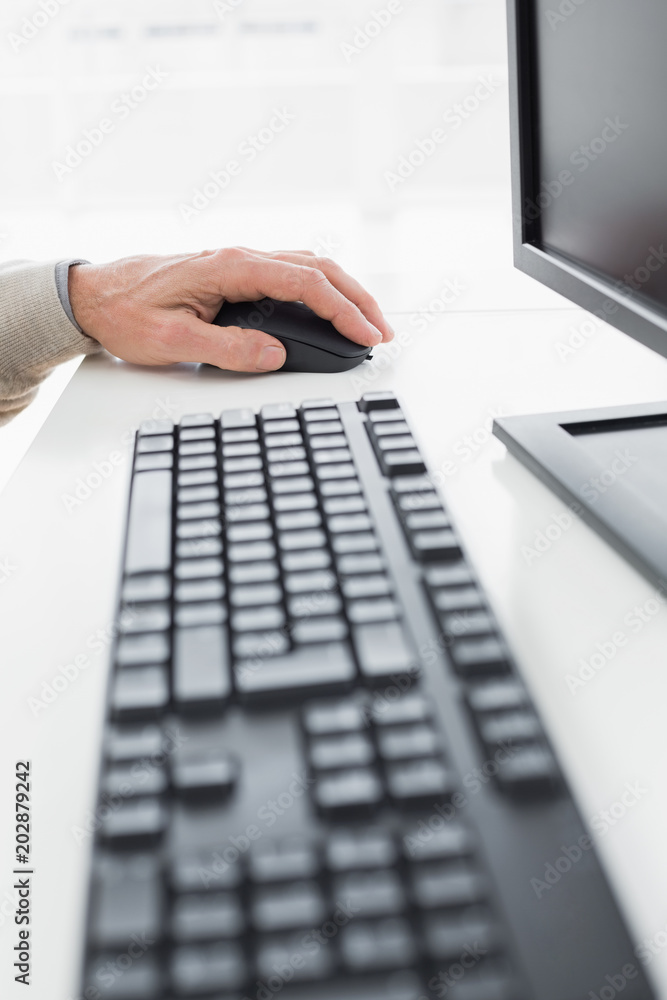 Closeup of a businessmans hand using computer mouse Closeup of a businessmans hand using computer mouse