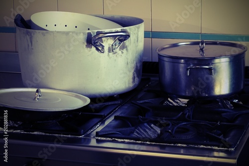 pots on the stove in the industrial kitchen with vintage effect