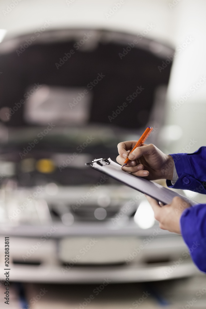 Focus on a man writing on a clipboard Focus on a man writing on a clipboard