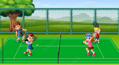 Happy kids playing tennis at the courts