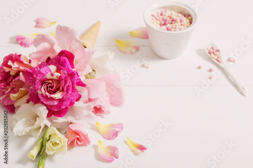 flowers in waffle cone on wooden background