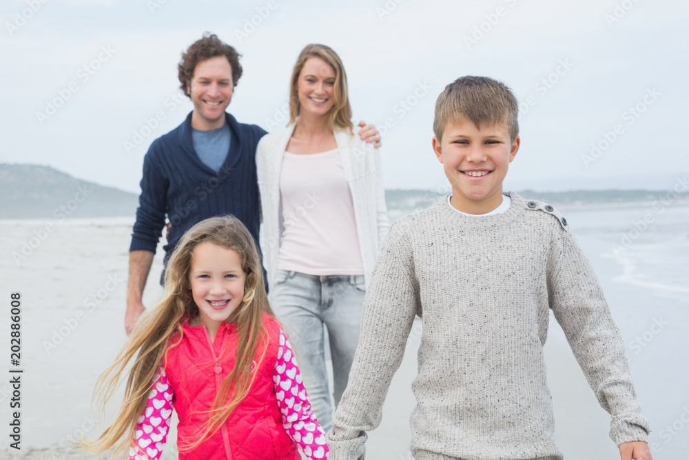 Happy family of four at the beach Happy family of four at the beach