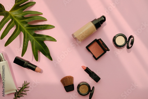 natural cosmetic makeup , organic skincare serum product packaging with leaves herb on nature beauty concept, herb bio and spa concept.pink background.