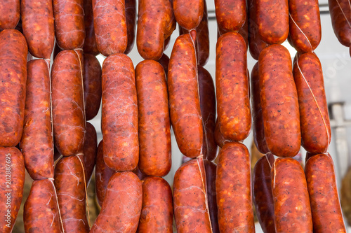 Strings of Hand Crafted Artisanal Sausages Red Chorizo Hanging at Farmers Market. Traditional Spanish Meat Specialty. Organic Local Produce. Lifestyle Image Authentic Atmosphere