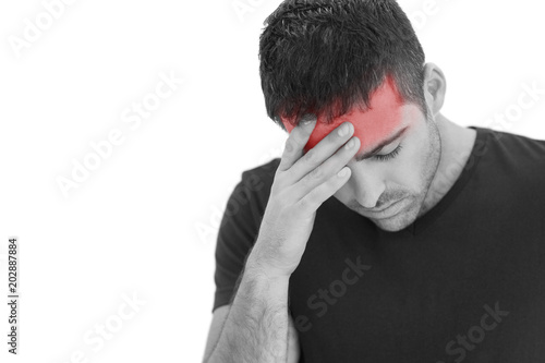 Upset man standing with his hand holding his forehead on white background