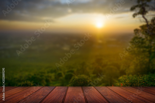 Wooden floor with tree and sky on sunset nature background
