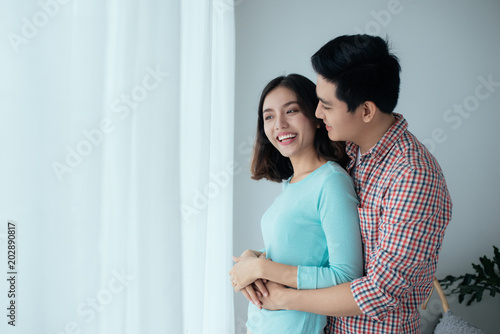 Sentimental happy asian couple in love bonding