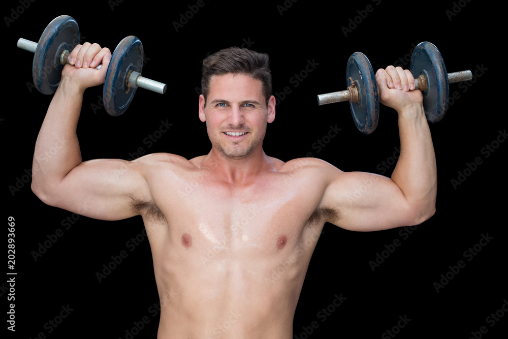 Strong crossfitter lifting up heavy black dumbbells Strong crossfitter lifting up heavy black dumbbells