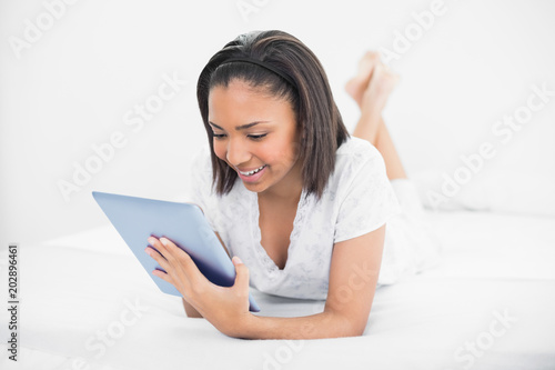 Stylish young dark haired model using a tablet pc