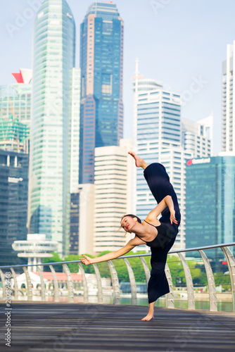 Elegant ballet dancer woman dancing ballet in the city