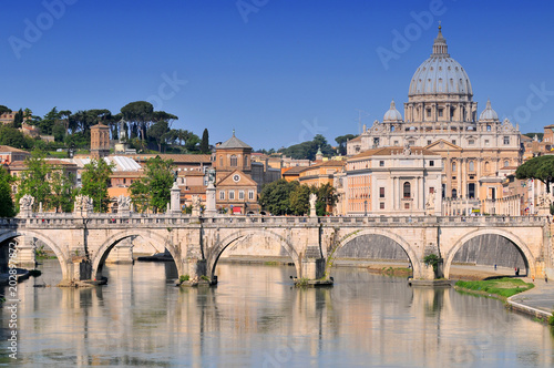 Tiber with Sant'Angelo bridge and the St. Peter's Basilica in Rome, Italy.