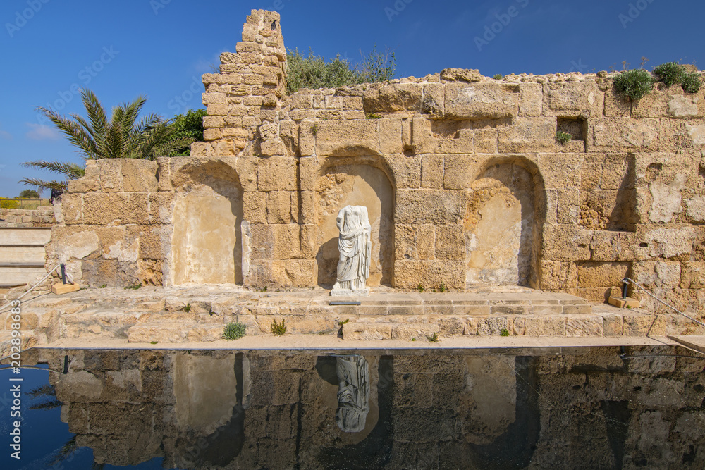 Roman emperor statue reflecting in a pool in Caesarea, Israel.
