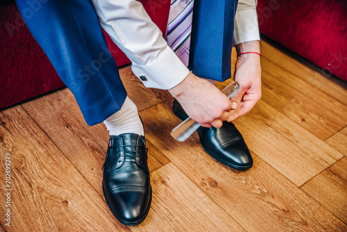 groom knots laces on his shoes