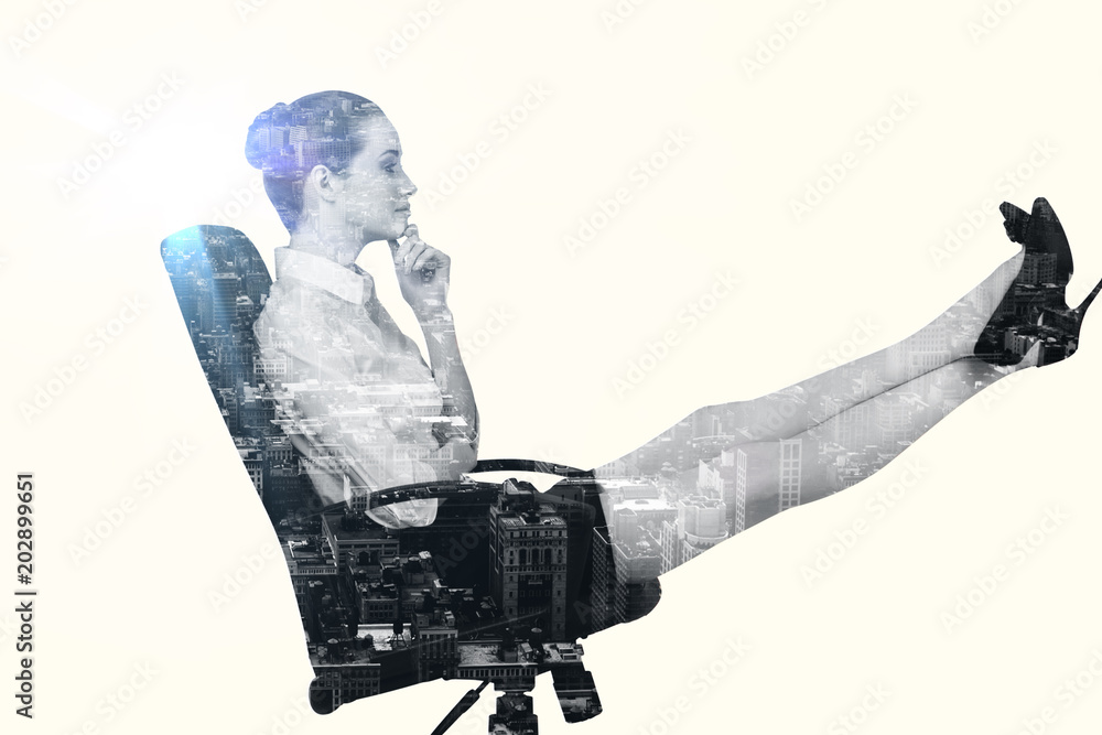 Φωτογραφία Businesswoman sitting on swivel chair with feet up against new york