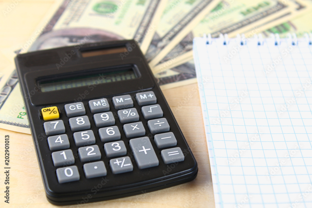 Finance concept : The United States hundred-dollar bills , calculator , bills. Finance concept : The United States hundred-dollar bills , calculator , bills.