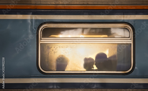 Silhouettes of passengers in old train wagon