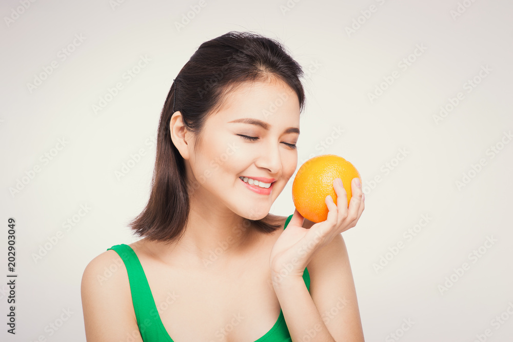 Beautiful asian portrait of young woman with oranges. Healthy food concept. Skin care and beauty. Vitamins and minerals. Beautiful asian portrait of young woman with oranges. Healthy food concept. Skin care and beauty. Vitamins and minerals.