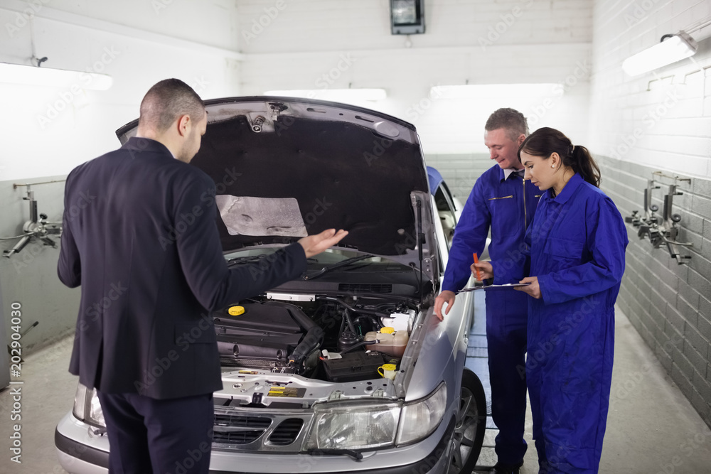 Client looking at a car engine Client looking at a car engine