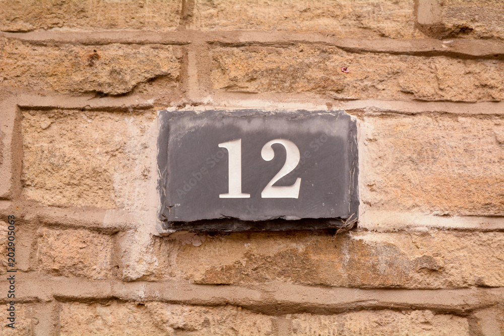 House number 12 sign on slate fixed to wall House number 12 sign on slate fixed to wall