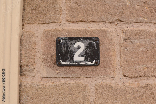 House number 2 metal tile on wall