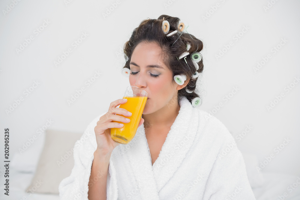Calm natural brunette drinking glass of orange juice Calm natural brunette drinking glass of orange juice