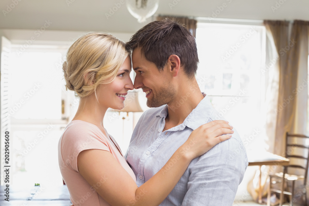 Loving couple looking at each other at home Loving couple looking at each other at home
