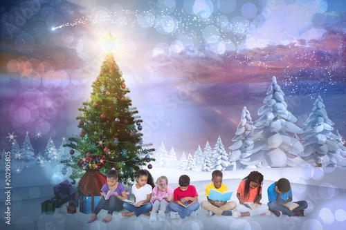 Composite image of cute children smiling at camera against snowy landscape with fir trees