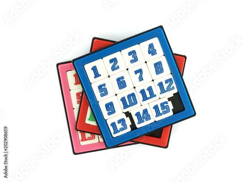 pile of colourful sliding 15 numbers puzzle game isolated on white, children toy for learning photo