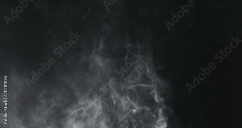 vapor steam rising over black background