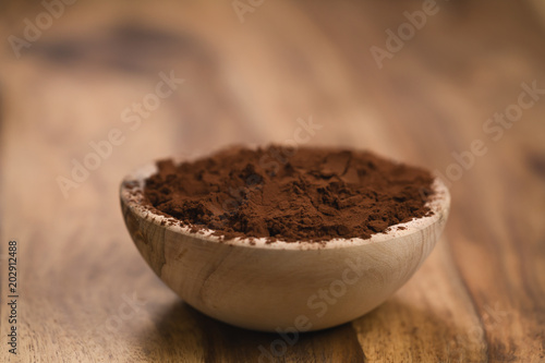 cacao powder in wood bowl on table