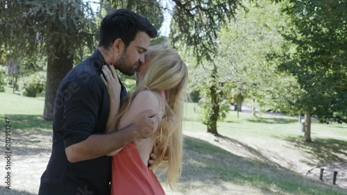 love, passion, desire - lovers kiss at the park- slow motion photo