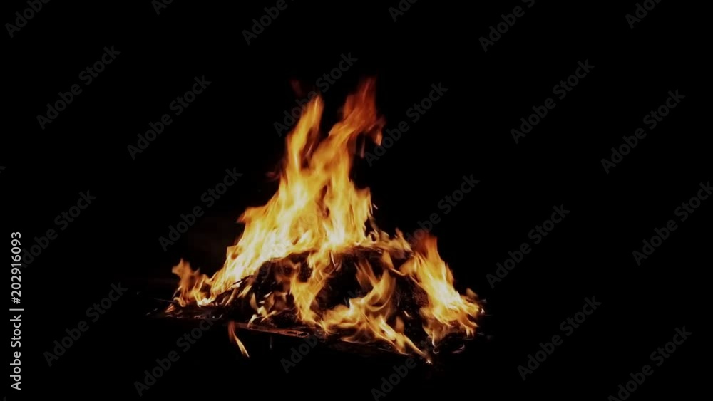 Fire burning against dark isolated background Fire burning against dark isolated background