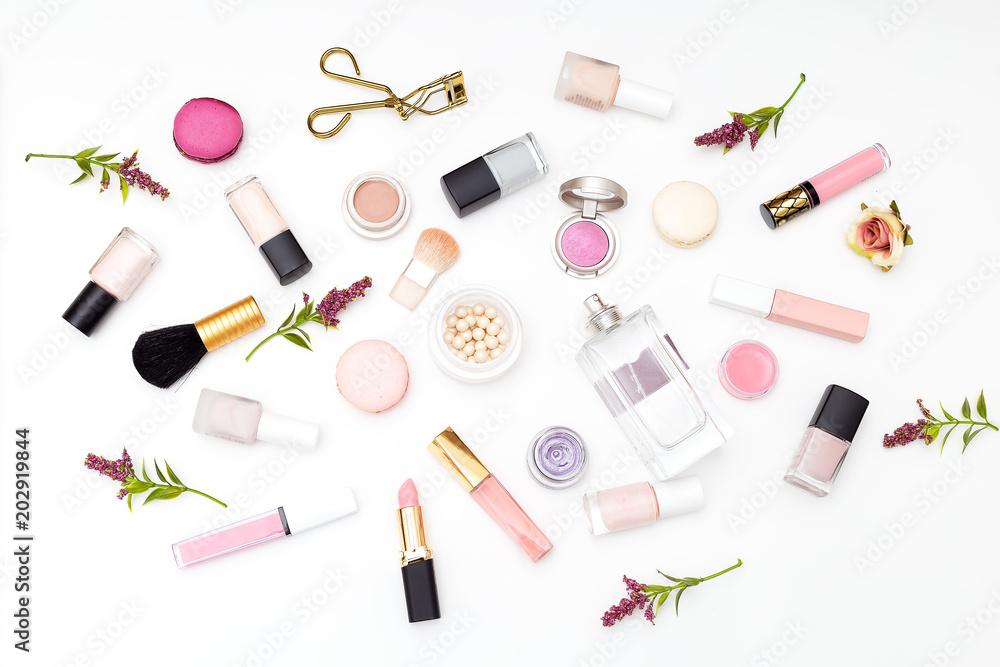 Set of cosmetics on a white background and twigs of flowers. Flat lay Set of cosmetics on a white background and twigs of flowers. Flat lay