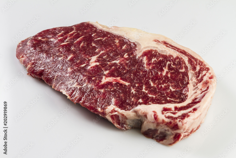Ripened seasoned beef rump or striploin steak on white background isolated Ripened seasoned beef rump or striploin steak on white background isolated