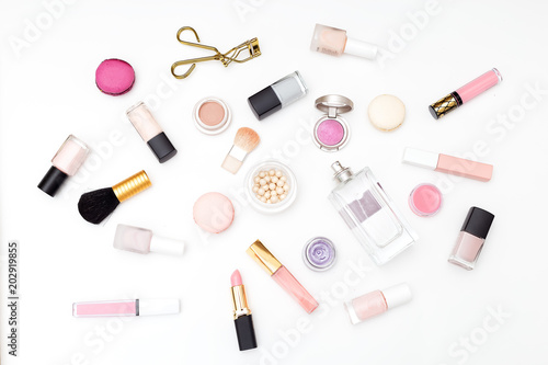 Set of cosmetics on a white background and macaroons. Flat lay