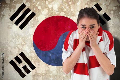 Nervous football fan looking ahead against south korea flag