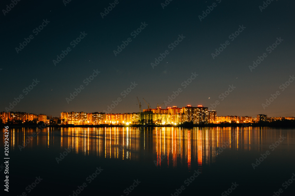 Panorama of city buildings lights reflection in water at night sky background, minimalism urban style