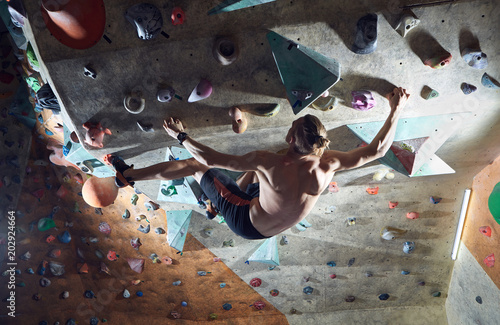 man climber climbs indoors photo