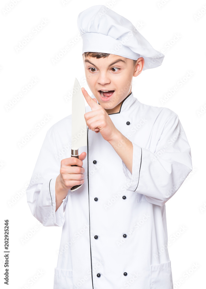 Handsome teen boy wearing chef uniform. Portrait of a cute male child cook with big knife, isolated on white background. Food and cooking concept. Handsome teen boy wearing chef uniform. Portrait of a cute male child cook with big knife, isolated on white background. Food and cooking concept.