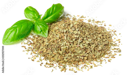 dried crushed basil leaves and fresh basil isolated on white