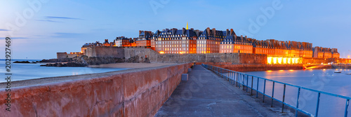 Panoramic night view of walled city Saint-Malo with St Vincent Cathedral, famous port city of Privateers is known as city corsaire, Brittany, France