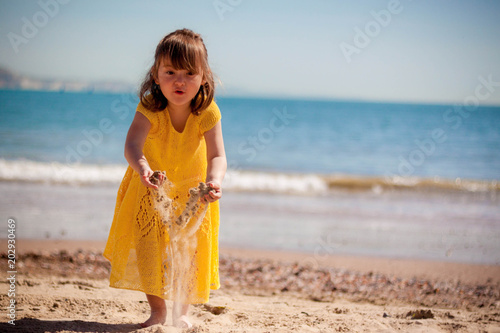 Happy little girl running on the beach
