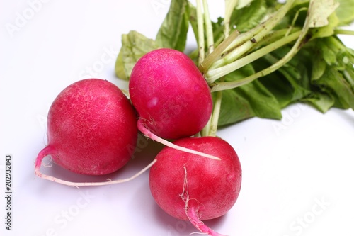 Pecok red radish with leaves on white background photo