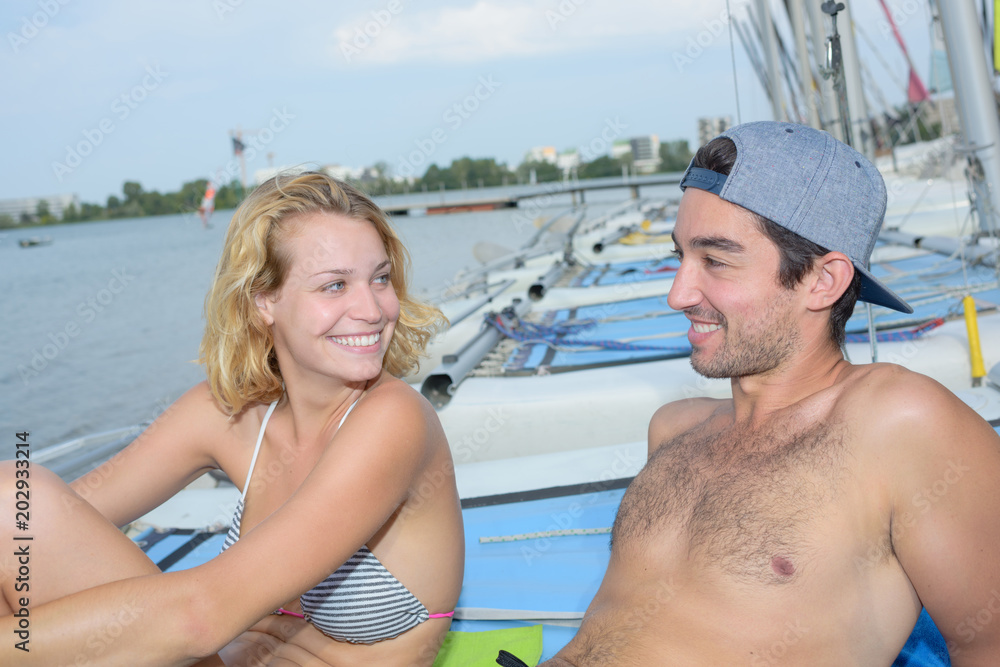 Fototapeta premium sunbathing on top of the sailboat